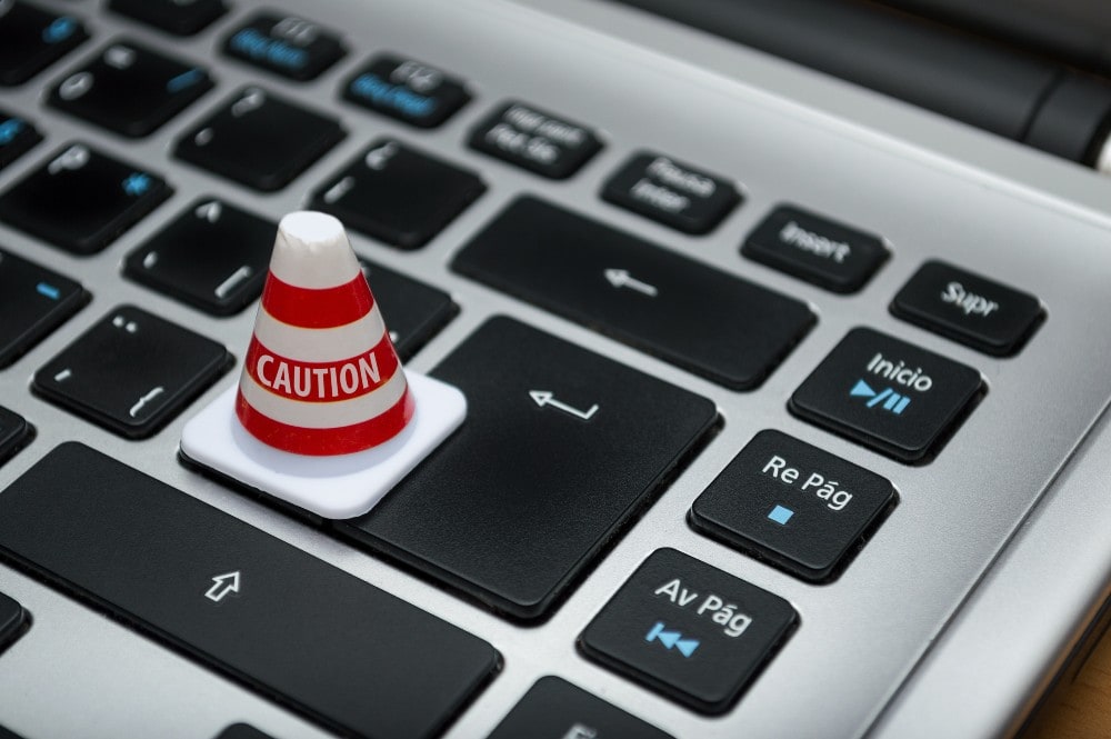 A keyboard with a caution cone on the enter key